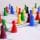 Close Up Photography of Yellow Green Red and Brown Plastic Cones on White Lined Surface